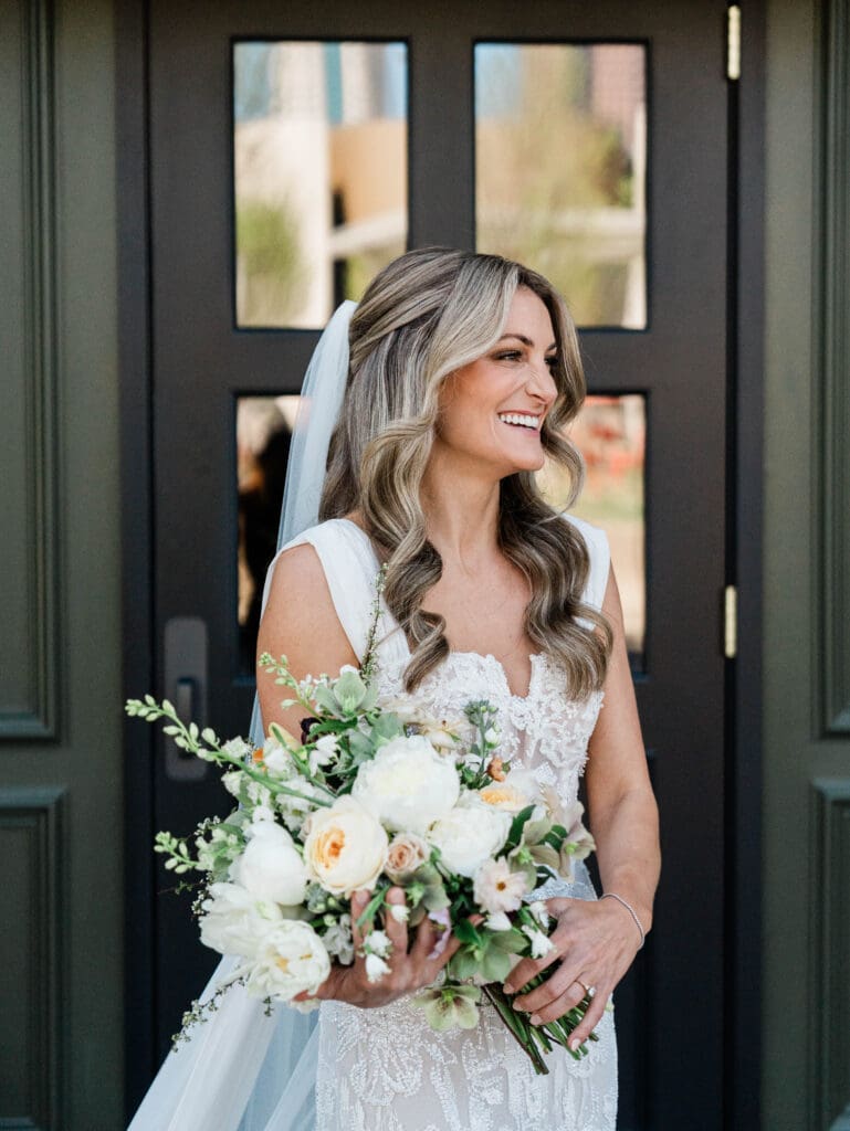 Bride with bouquet of flowers; wedding color palettes for 2026